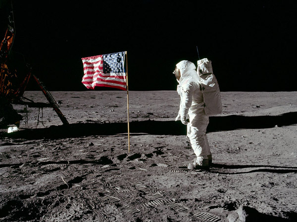 Apollo 11 Aldrin poses next to the Stars and Stripes